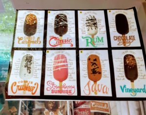 An ice cream freezer chest shows various pops.