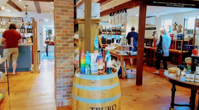 The photo shows the interior of a ift shop with a wine barrel