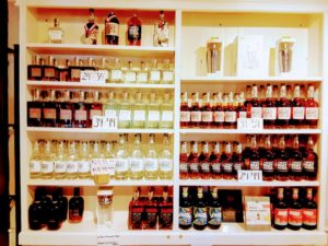Rows of liquor bottles line a cabinet